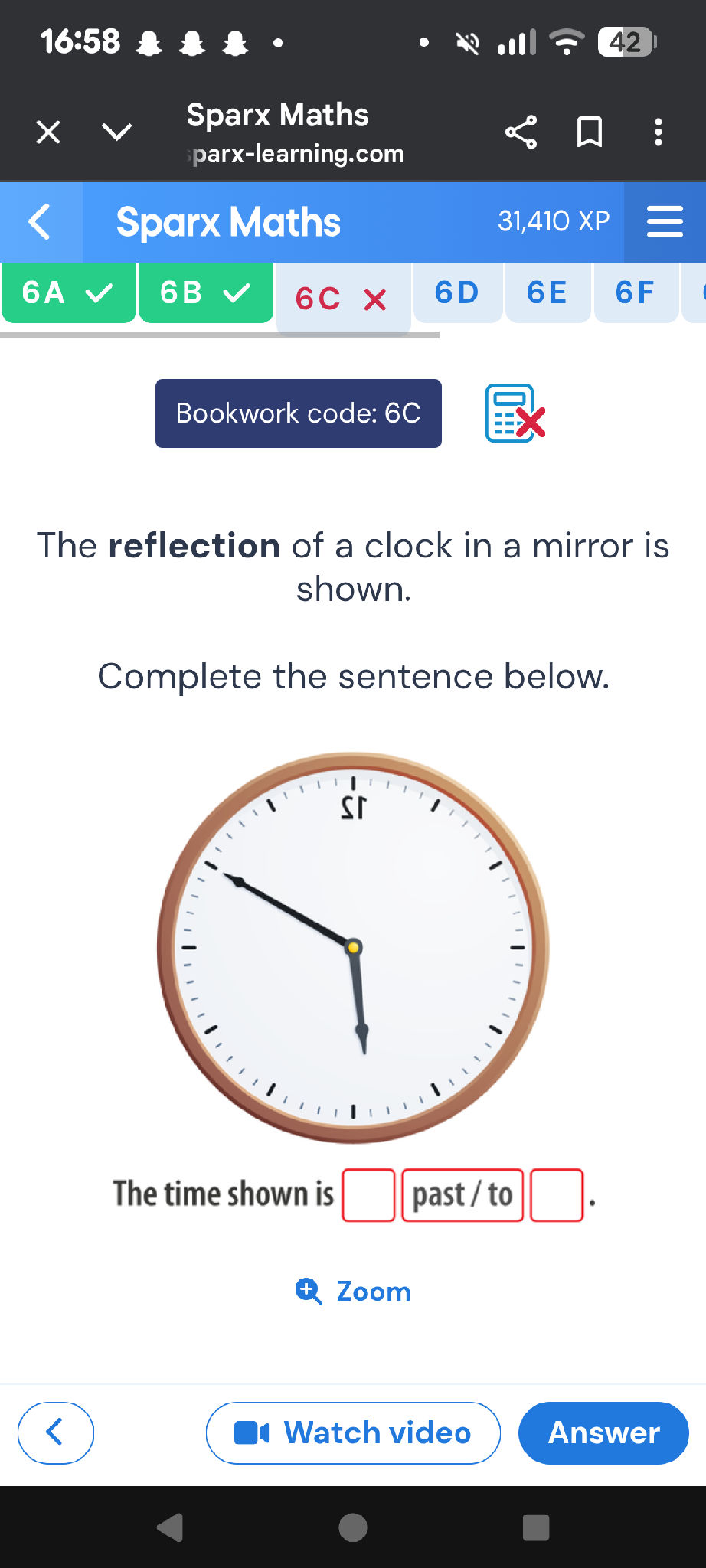 The reflection of a clock in a mirror is